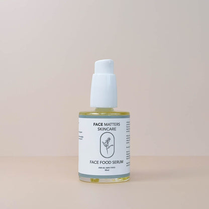 Face Matters Skincare Face Food Serum in a clear glass bottle with a white pump dispenser on a neutral background.